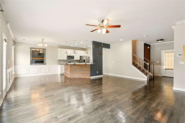 119 Hardy Water Dr, Lawrenceville, GA 30045 - unfurnished living room with stairway, ceiling fan, crown molding, dark wood finished floors, and recessed lighting