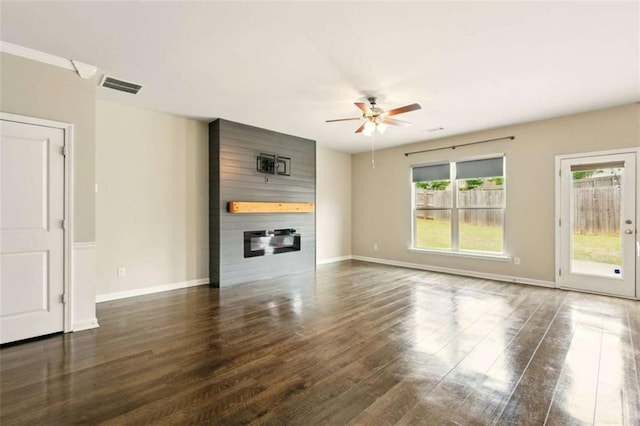 119 Hardy Water Dr, Lawrenceville, GA 30045 - unfurnished living room featuring ceiling fan, a large fireplace, dark wood finished floors, and baseboards