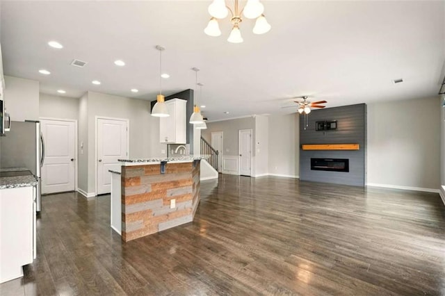 119 Hardy Water Dr, Lawrenceville, GA 30045 - kitchen with baseboards, white cabinets, a chandelier, recessed lighting, and light stone countertops
