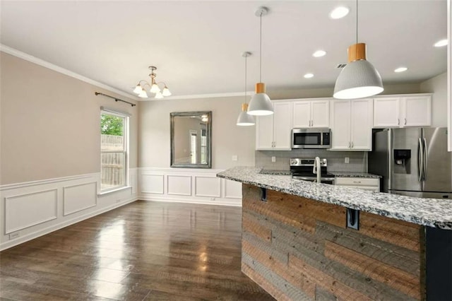 119 Hardy Water Dr, Lawrenceville, GA 30045 - kitchen featuring appliances with stainless steel finishes, light stone counters, ornamental molding, white cabinets, and dark wood finished floors