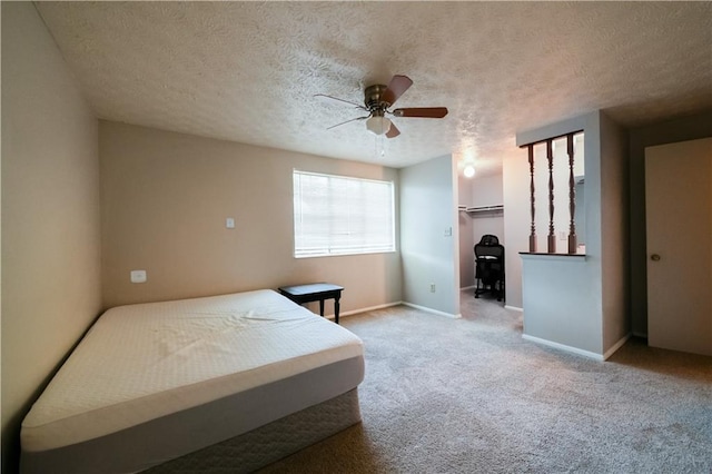 1406 Springleaf Cir SE, Smyrna, GA 30080 - carpeted bedroom featuring a textured ceiling, baseboards, a ceiling fan, and a walk in closet