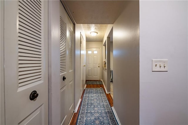 1406 Springleaf Cir SE, Smyrna, GA 30080 - corridor featuring a textured ceiling, baseboards, and dark wood-style floors
