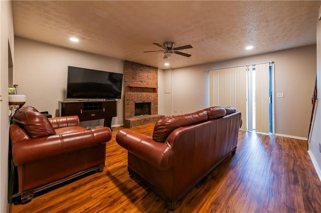 1406 Springleaf Cir SE, Smyrna, GA 30080 - living area with a ceiling fan, dark wood-style floors, a textured ceiling, a fireplace, and recessed lighting