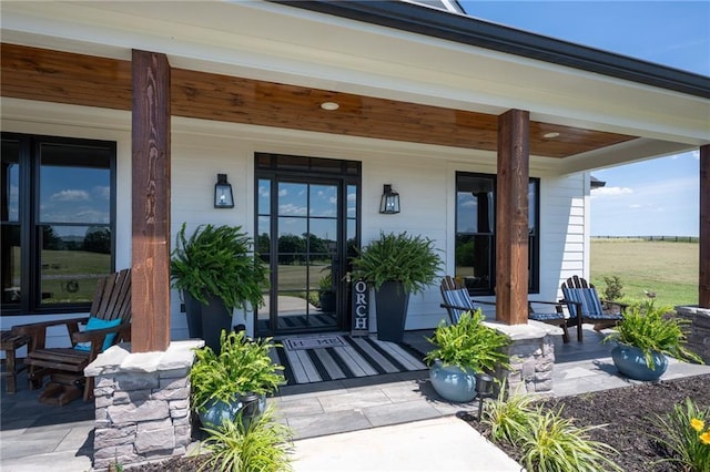 doorway to property featuring covered porch