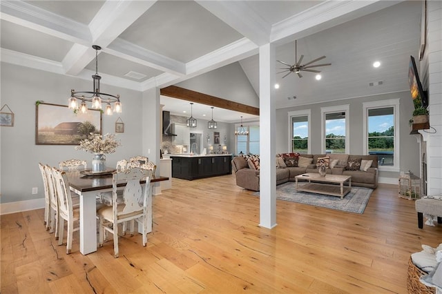 dining area with crown molding, vaulted ceiling with beams, ceiling fan with notable chandelier, and light wood-type flooring