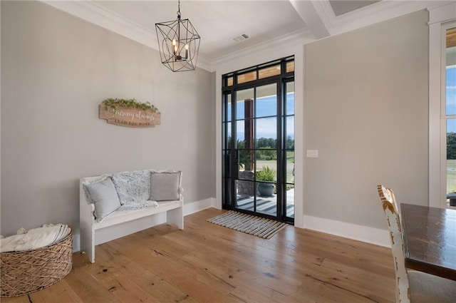 doorway featuring crown molding, a notable chandelier, beamed ceiling, and hardwood / wood-style flooring