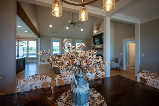 dining area featuring crown molding, ceiling fan, high vaulted ceiling, and hardwood / wood-style flooring