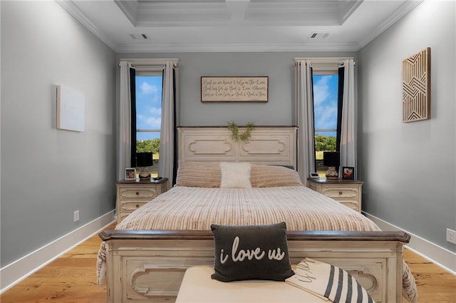 bedroom with multiple windows, crown molding, and light hardwood / wood-style floors