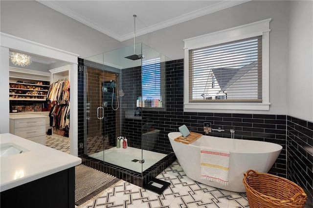 bathroom with ornamental molding, tile walls, vanity, and plus walk in shower