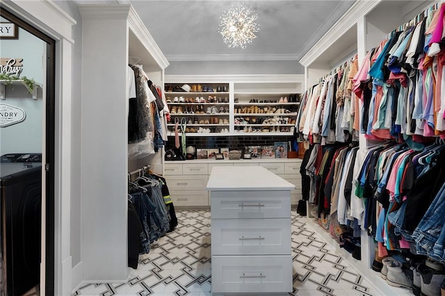 spacious closet featuring washer / clothes dryer and a notable chandelier