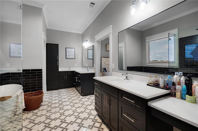 bathroom featuring vanity, tile walls, a washtub, and crown molding