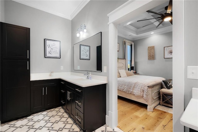 bathroom with vanity, hardwood / wood-style floors, ornamental molding, and ceiling fan