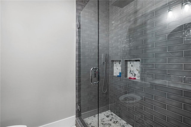 bathroom featuring a shower with door