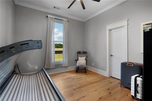 interior space featuring crown molding, ceiling fan, and light hardwood / wood-style floors