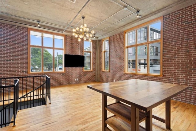 660 Glen Iris Drive # 206 & 109, Atlanta, GA 30308 - dining area with brick wall, light wood finished floors, and a chandelier