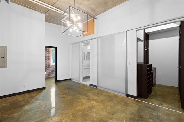 660 Glen Iris Drive # 206 & 109, Atlanta, GA 30308 - unfurnished dining area featuring a chandelier, concrete floors, and baseboards