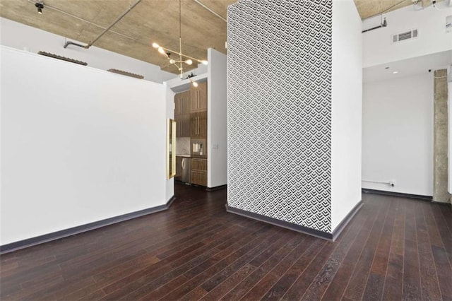 660 Glen Iris Drive # 206 & 109, Atlanta, GA 30308 - empty room featuring an accent wall, a towering ceiling, dark wood finished floors, baseboards, and a chandelier