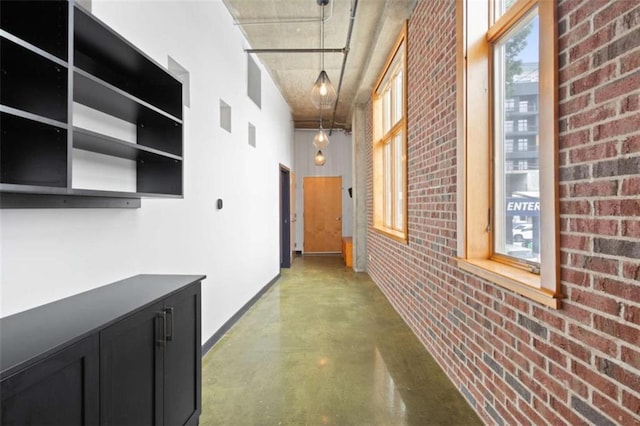 660 Glen Iris Drive # 206 & 109, Atlanta, GA 30308 - hallway featuring finished concrete flooring, baseboards, and brick wall