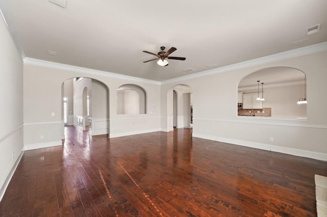 unfurnished living room with crown molding, ceiling fan, and dark wood-type flooring