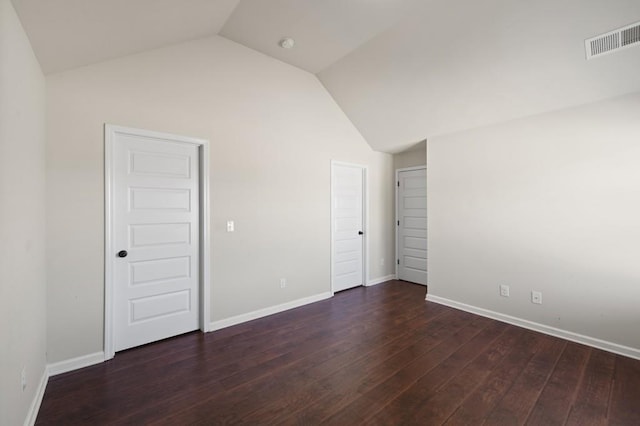 unfurnished bedroom featuring dark hardwood / wood-style flooring and vaulted ceiling