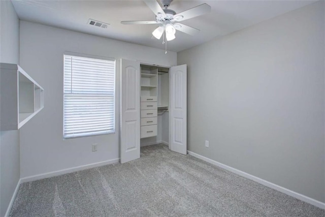 unfurnished bedroom featuring light carpet, baseboards, visible vents, a ceiling fan, and a closet