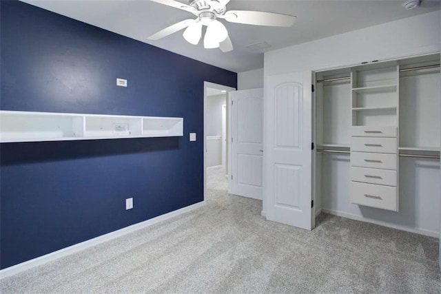 unfurnished bedroom featuring light carpet, a closet, and baseboards