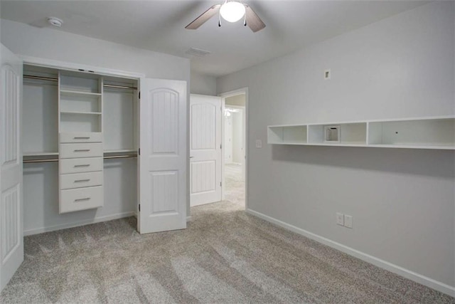 unfurnished bedroom with a closet, light colored carpet, visible vents, a ceiling fan, and baseboards