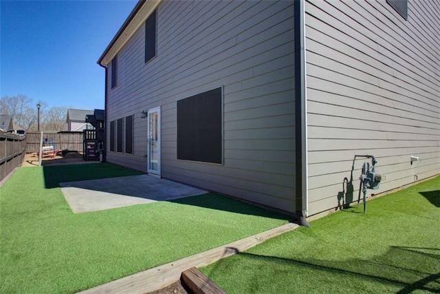 view of home's exterior featuring a yard, fence, and a patio