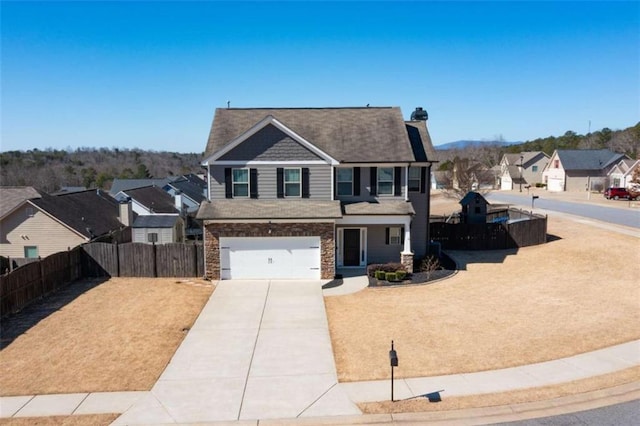 view of front facade featuring a garage, a residential view, fence, and driveway