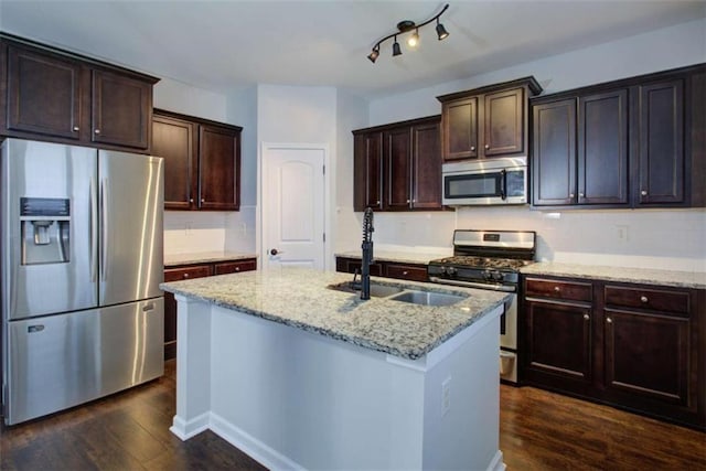 kitchen featuring stainless steel appliances, light stone counters, and dark wood-type flooring