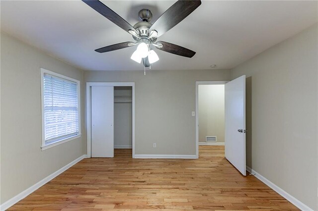 unfurnished bedroom with light wood-type flooring and ceiling fan