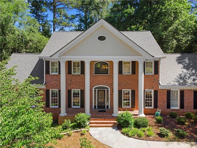 2595 Winthrope Way, Lawrenceville, GA 30044 - neoclassical / greek revival house featuring covered porch, brick siding, and a shingled roof