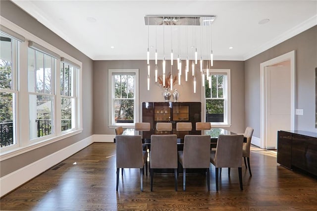 dining room featuring dark wood-type flooring, recessed lighting, baseboards, and ornamental molding