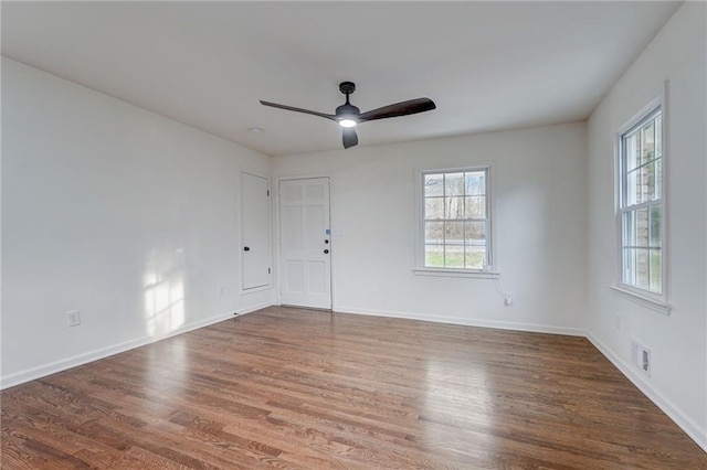 unfurnished room featuring wood-type flooring, ceiling fan, and a healthy amount of sunlight