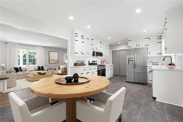 dining room featuring dark tile patterned floors and sink