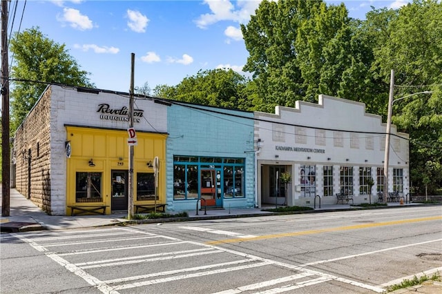 view of building exterior with uncovered parking