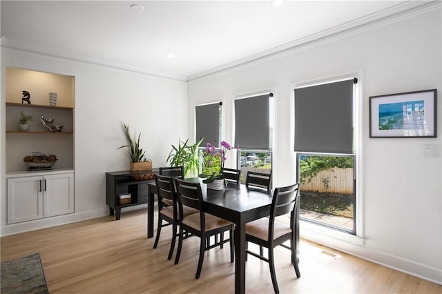 dining space with recessed lighting, baseboards, crown molding, and light wood-style flooring
