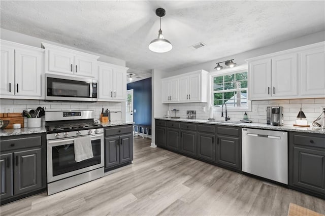 219 Summit Chase Dr, Jefferson, GA 30549 - kitchen featuring appliances with stainless steel finishes, gray cabinets, white cabinets, and decorative backsplash