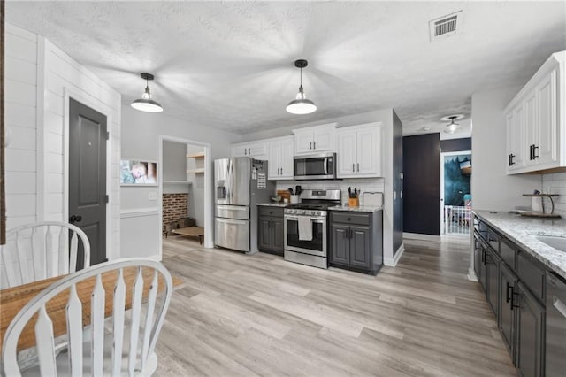 219 Summit Chase Dr, Jefferson, GA 30549 - kitchen with appliances with stainless steel finishes, white cabinets, and pendant lighting