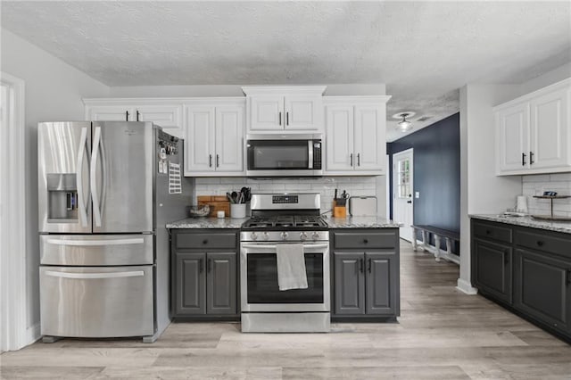 219 Summit Chase Dr, Jefferson, GA 30549 - kitchen with stainless steel appliances, gray cabinetry, white cabinetry, and a textured ceiling