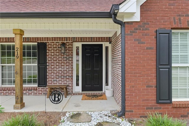 219 Summit Chase Dr, Jefferson, GA 30549 - doorway to property with brick siding, a porch, and roof with shingles