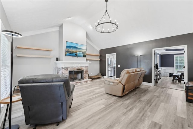 219 Summit Chase Dr, Jefferson, GA 30549 - living room featuring a chandelier, lofted ceiling, wood finished floors, a brick fireplace, and baseboards