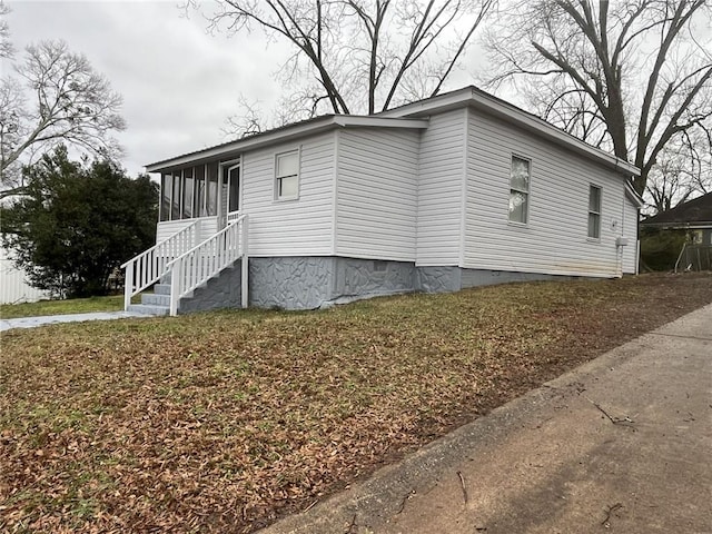 view of property exterior featuring a sunroom