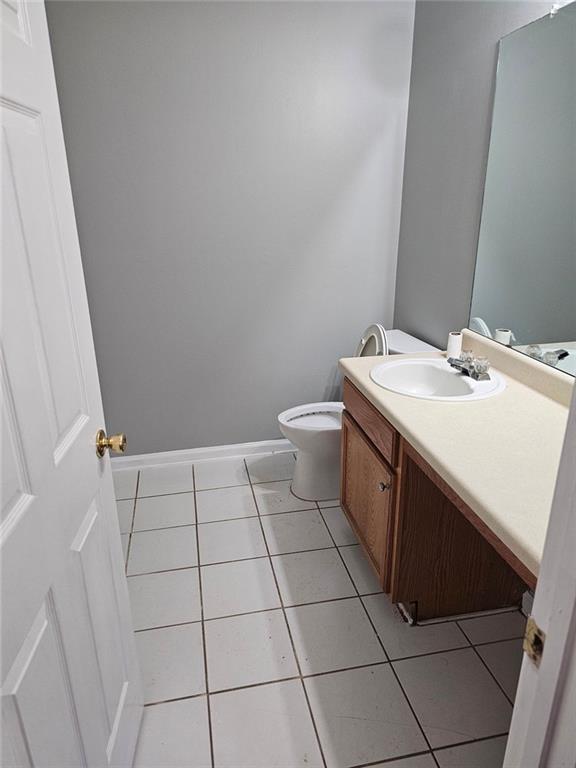 bathroom with vanity, tile patterned floors, and toilet