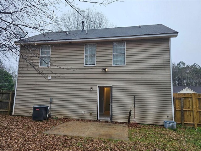 back of house featuring central AC unit and a patio area