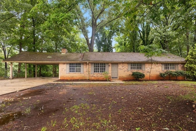 1513 Dupree Rd, Woodstock, GA 30189 - single story home featuring brick siding, a chimney, driveway, and a carport