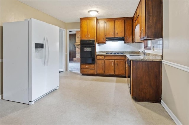 1513 Dupree Rd, Woodstock, GA 30189 - kitchen featuring black appliances, a warming drawer, under cabinet range hood, brown cabinets, and decorative backsplash