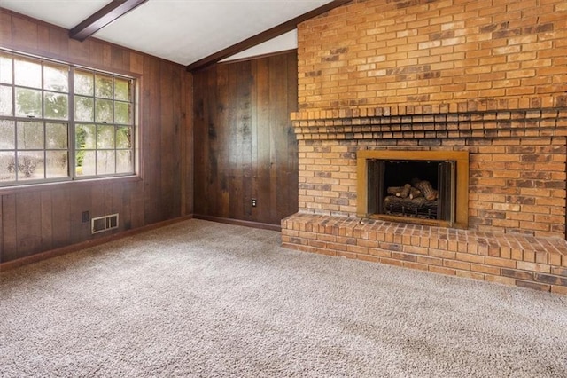 1513 Dupree Rd, Woodstock, GA 30189 - unfurnished living room featuring wooden walls, beam ceiling, carpet floors, and a fireplace