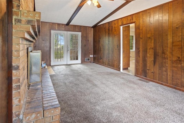 1513 Dupree Rd, Woodstock, GA 30189 - unfurnished living room featuring wood walls, carpet flooring, ceiling fan, and french doors