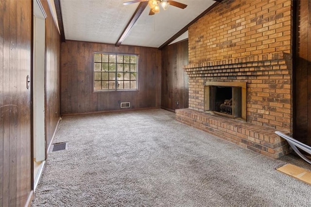 1513 Dupree Rd, Woodstock, GA 30189 - unfurnished living room with a ceiling fan, a brick fireplace, carpet, wood walls, and a textured ceiling